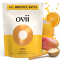 Ovii supplement package with oranges, mango, and a scoop of powder on a white background